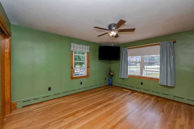 10 Eastern Ave, Rochester, NH 03867 - spare room with wood finished floors, a ceiling fan, and a baseboard heating unit