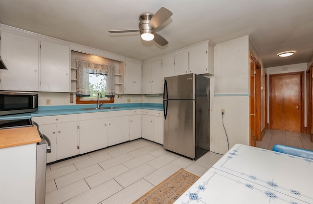 10 Eastern Ave, Rochester, NH 03867 - kitchen featuring stainless steel appliances, open shelves, ceiling fan, white cabinetry, and light countertops