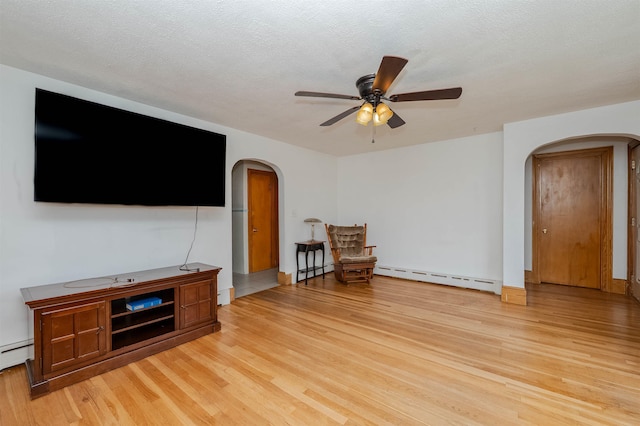 10 Eastern Ave, Rochester, NH 03867 - unfurnished living room with arched walkways, a baseboard heating unit, light wood finished floors, ceiling fan, and baseboard heating