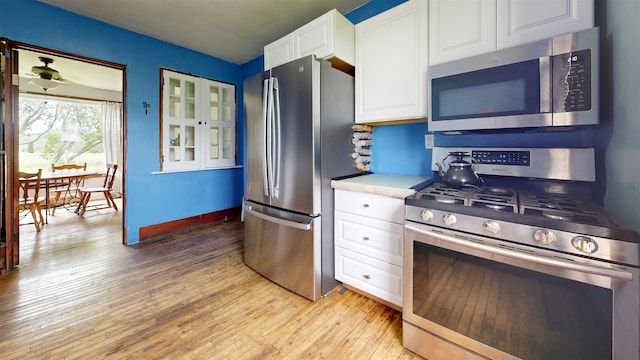 180 E Shore S, Grand Isle, VT 05458 - kitchen featuring appliances with stainless steel finishes, light wood-style floors, white cabinetry, and light countertops