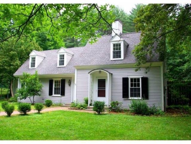 649 Court St, Keene, NH 03431 - new england style home featuring a front lawn, a shingled roof, and a chimney