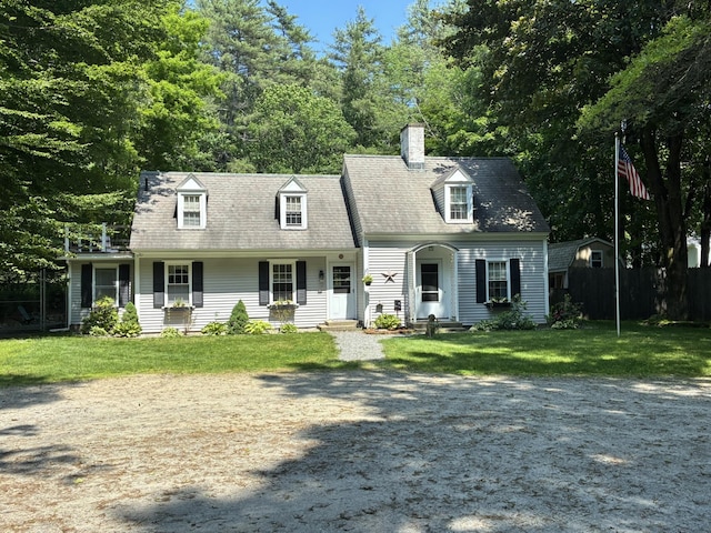 649 Court St, Keene, NH 03431 - cape cod-style house with a front lawn, a chimney, and view of wooded area