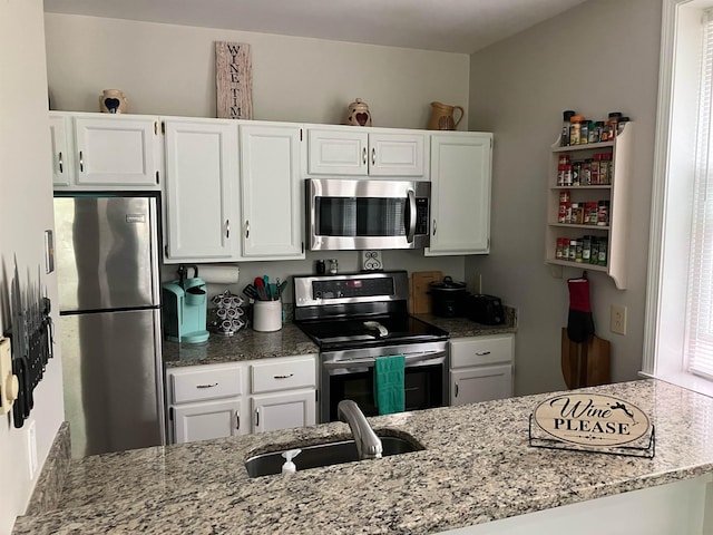 45 Kancamagus Hwy Unit 2, Woodstock, NH 03262 - kitchen featuring appliances with stainless steel finishes, light stone countertops, and white cabinets