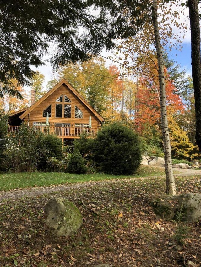 67 Cardinal Ln, Smithfield, ME 04978 - view of property exterior featuring a chimney and a wooden deck