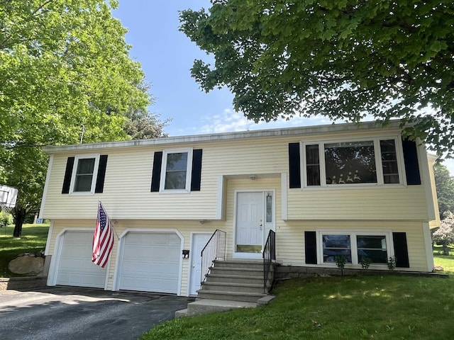 13 Bartlett St, Allenstown, NH 03275 - split foyer home with a garage, driveway, and a front lawn