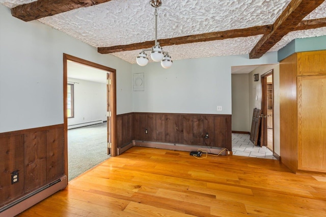 240 Middle Winchendon Rd, Rindge, NH 03461 - unfurnished dining area with a baseboard radiator, light wood-style flooring, baseboard heating, beamed ceiling, and a chandelier
