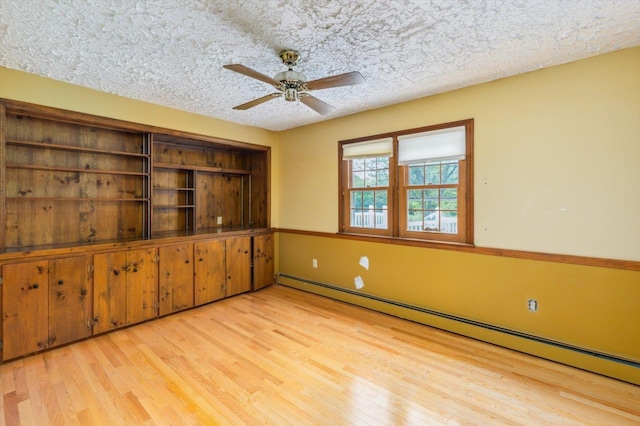 240 Middle Winchendon Rd, Rindge, NH 03461 - empty room with baseboard heating, wood finished floors, a ceiling fan, and a textured ceiling