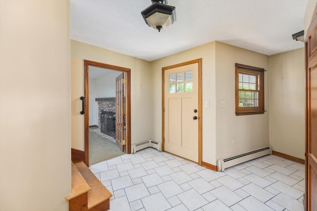 240 Middle Winchendon Rd, Rindge, NH 03461 - entrance foyer featuring baseboard heating, a fireplace, and a textured ceiling