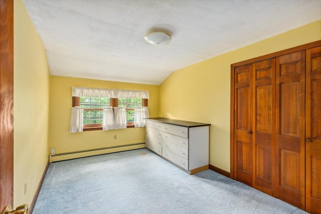 240 Middle Winchendon Rd, Rindge, NH 03461 - unfurnished bedroom featuring a baseboard heating unit, lofted ceiling, carpet, a textured ceiling, and a closet