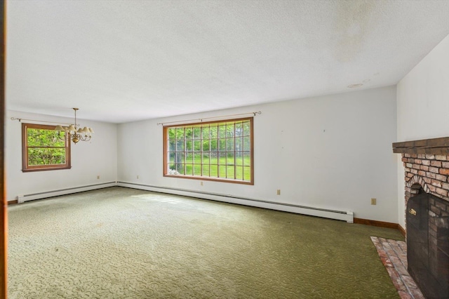 240 Middle Winchendon Rd, Rindge, NH 03461 - unfurnished living room with a chandelier, carpet flooring, a fireplace, a baseboard radiator, and a textured ceiling