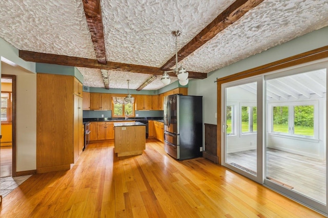 240 Middle Winchendon Rd, Rindge, NH 03461 - kitchen featuring freestanding refrigerator, light wood finished floors, dishwasher, a center island, and beam ceiling