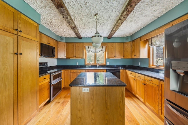 240 Middle Winchendon Rd, Rindge, NH 03461 - kitchen with black appliances, a kitchen island, plenty of natural light, light wood-style flooring, and beamed ceiling