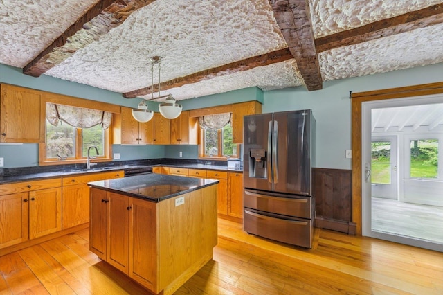 240 Middle Winchendon Rd, Rindge, NH 03461 - kitchen featuring stainless steel fridge with ice dispenser, beamed ceiling, healthy amount of natural light, light wood-style flooring, and wainscoting