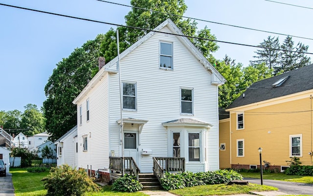 4 Walnut St, Exeter, NH 03833 - view of front of home featuring a front lawn and a chimney