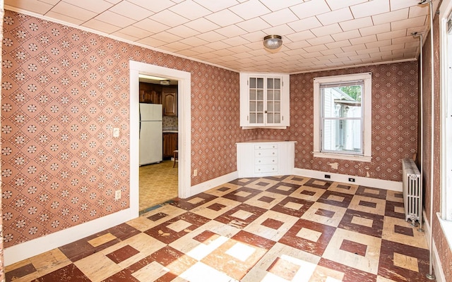 4 Walnut St, Exeter, NH 03833 - spare room with radiator, light flooring, and crown molding