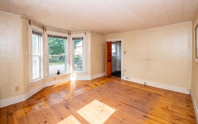 4 Walnut St, Exeter, NH 03833 - spare room with hardwood / wood-style flooring and crown molding