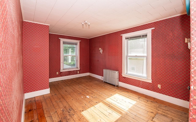 4 Walnut St, Exeter, NH 03833 - spare room featuring radiator, crown molding, hardwood / wood-style flooring, and wallpapered walls