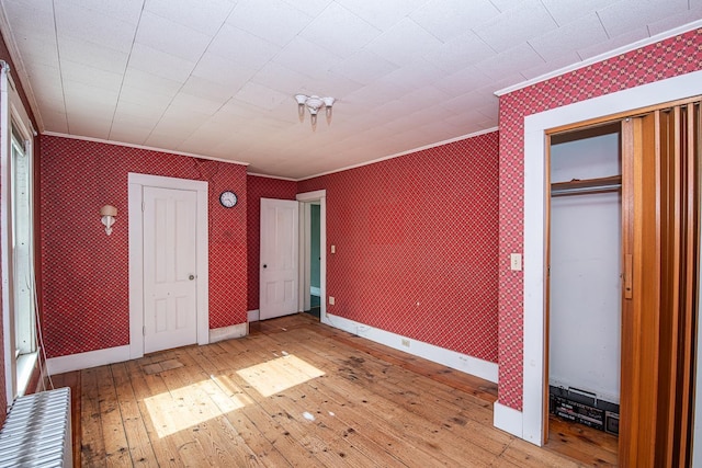 4 Walnut St, Exeter, NH 03833 - unfurnished bedroom featuring wallpapered walls, ornamental molding, and hardwood / wood-style floors