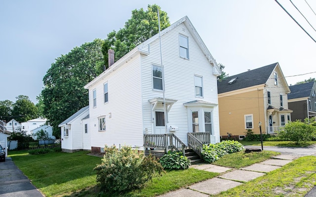 4 Walnut St, Exeter, NH 03833 - view of front facade featuring a front lawn and a chimney