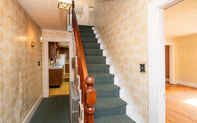 4 Walnut St, Exeter, NH 03833 - stairway featuring wallpapered walls and hardwood / wood-style floors