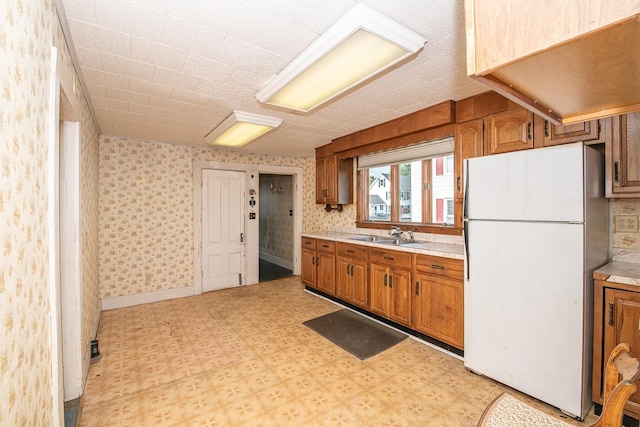 4 Walnut St, Exeter, NH 03833 - kitchen featuring freestanding refrigerator, light flooring, brown cabinets, light countertops, and wallpapered walls