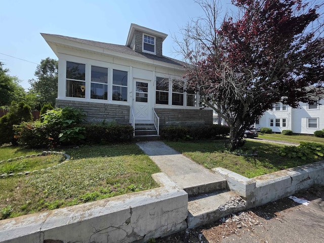 793 S Beech St, Manchester, NH 03104 - view of front of property with entry steps, stone siding, and a front lawn