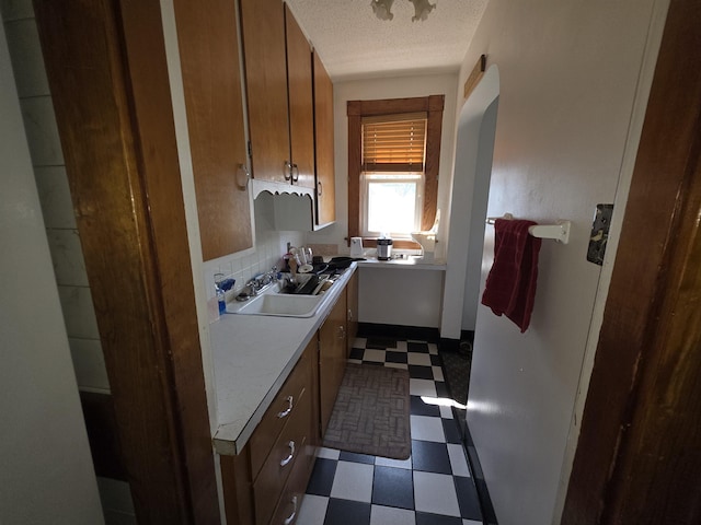 793 S Beech St, Manchester, NH 03104 - kitchen featuring dark flooring, light countertops, arched walkways, and a textured ceiling