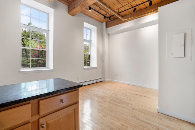 156 Front St Unit 103, Exeter, NH 03833 - spare room featuring a wood ceiling with exposed beams, baseboard heating, electric panel, light wood finished floors, and rail lighting