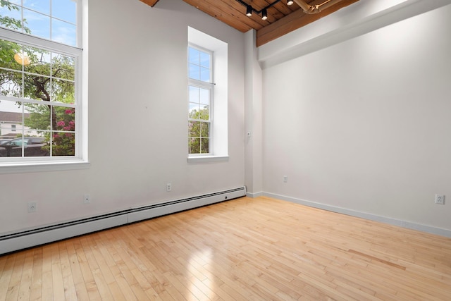 156 Front St Unit 103, Exeter, NH 03833 - empty room featuring a baseboard heating unit, wood ceiling, hardwood / wood-style floors, and track lighting