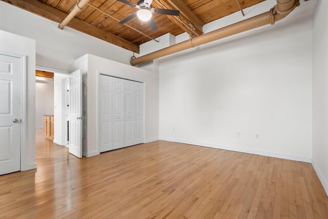 156 Front St Unit 103, Exeter, NH 03833 - unfurnished bedroom featuring a wooden ceiling with exposed beams, light wood finished floors, and a closet