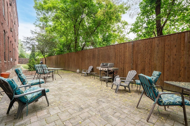 156 Front St Unit 103, Exeter, NH 03833 - fenced backyard with a patio area, outdoor dining area, and grilling area