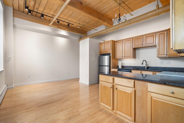 156 Front St Unit 103, Exeter, NH 03833 - kitchen featuring a wood ceiling with exposed beams, rail lighting, freestanding refrigerator, light wood-type flooring, and a peninsula