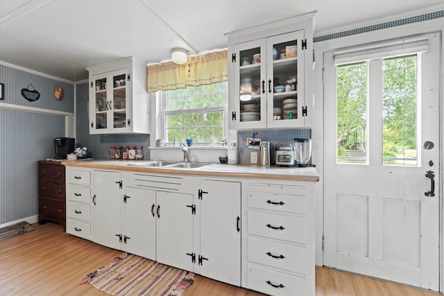 235 Dartmouth College Hwy, Haverhill, NH 03765 - kitchen with light countertops, light wood-style floors, white cabinets, and crown molding