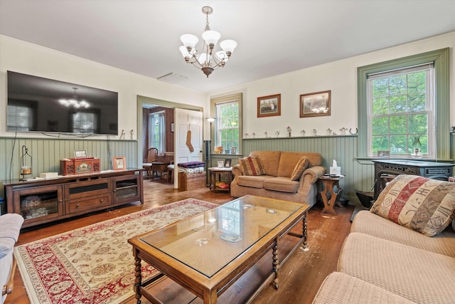 235 Dartmouth College Hwy, Haverhill, NH 03765 - living room featuring a chandelier, wainscoting, and wood finished floors