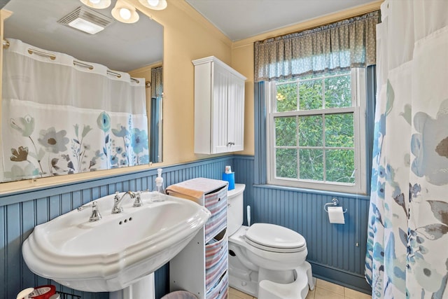 235 Dartmouth College Hwy, Haverhill, NH 03765 - bathroom with wainscoting, crown molding, tile patterned floors, and curtained shower