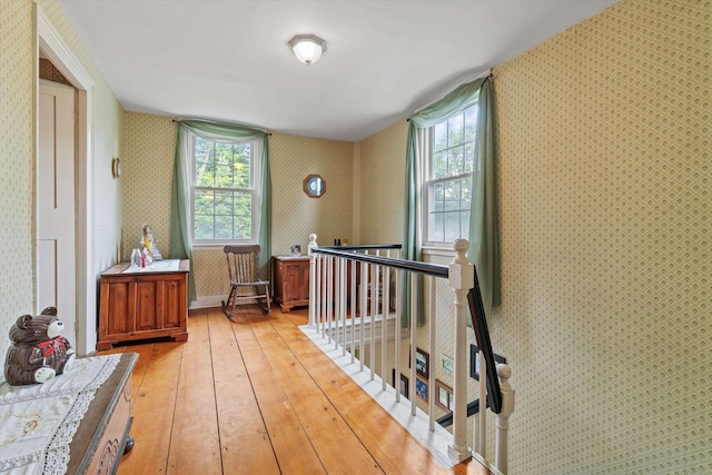 235 Dartmouth College Hwy, Haverhill, NH 03765 - corridor featuring wallpapered walls, an upstairs landing, light wood-type flooring, and healthy amount of natural light