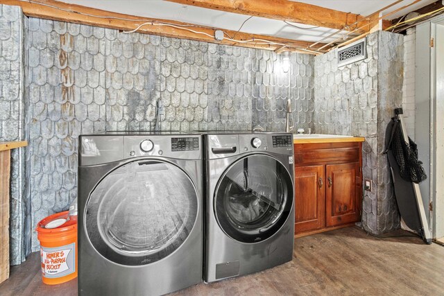235 Dartmouth College Hwy, Haverhill, NH 03765 - laundry area with cabinet space, washing machine and dryer, and wood finished floors