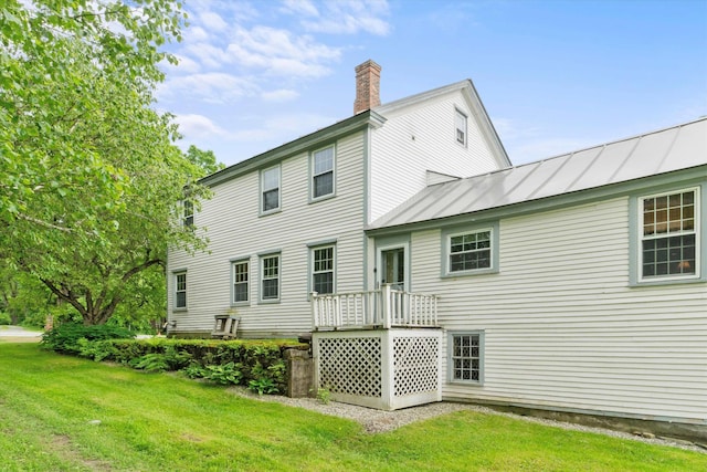 235 Dartmouth College Hwy, Haverhill, NH 03765 - back of house with a standing seam roof, a chimney, a yard, and a metal roof