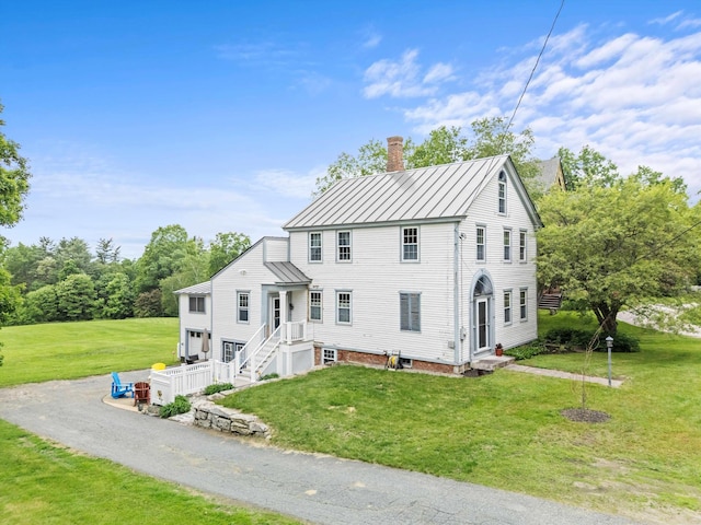 235 Dartmouth College Hwy, Haverhill, NH 03765 - view of front facade featuring a standing seam roof, a chimney, a metal roof, and a front lawn