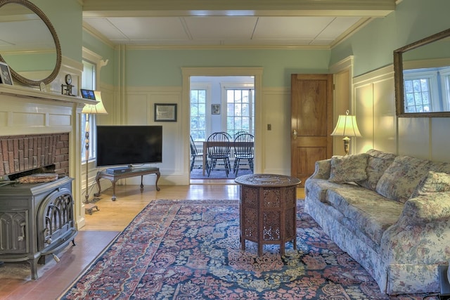 45 School St, Keene, NH 03431 - living area with a decorative wall, wood finished floors, healthy amount of natural light, a wood stove, and wainscoting