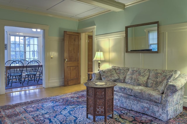 45 School St, Keene, NH 03431 - living area featuring a decorative wall, wood finished floors, ornamental molding, and wainscoting