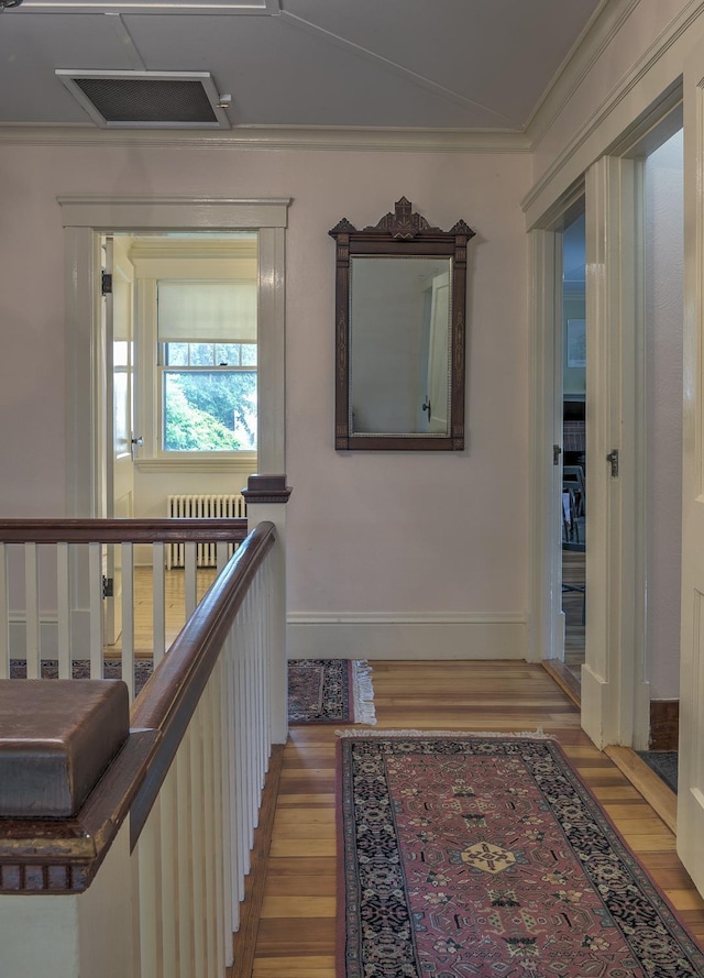 45 School St, Keene, NH 03431 - hallway featuring radiator heating unit, light wood finished floors, attic access, and ornamental molding