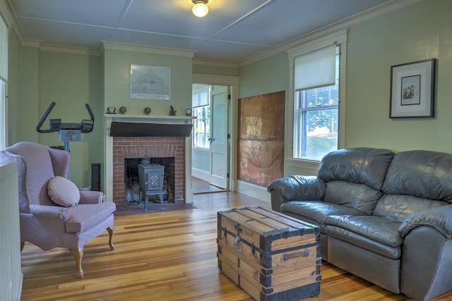 45 School St, Keene, NH 03431 - living area featuring light wood-style flooring, a wood stove, and ornamental molding