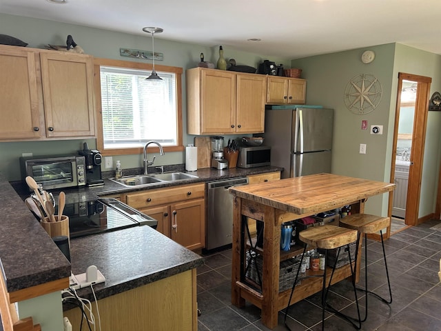26 Island Dr, Madison, NH 03849 - kitchen with appliances with stainless steel finishes, light brown cabinets, dark countertops, and hanging light fixtures