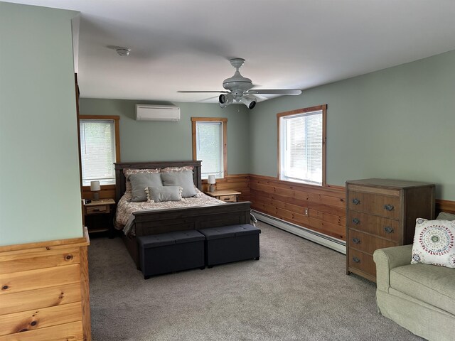 26 Island Dr, Madison, NH 03849 - bedroom with a baseboard radiator, an AC wall unit, multiple windows, wainscoting, and carpet