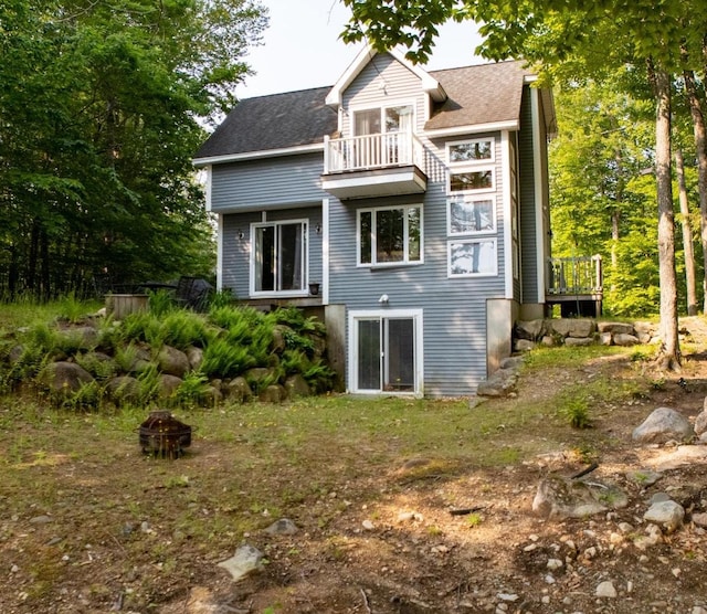 26 Island Dr, Madison, NH 03849 - rear view of house with a balcony and a fire pit