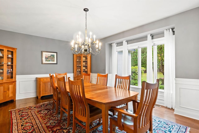 9 Hubbard Rd, Amherst, NH 03031 - dining area featuring plenty of natural light, a chandelier, a wainscoted wall, dark wood-type flooring, and a decorative wall