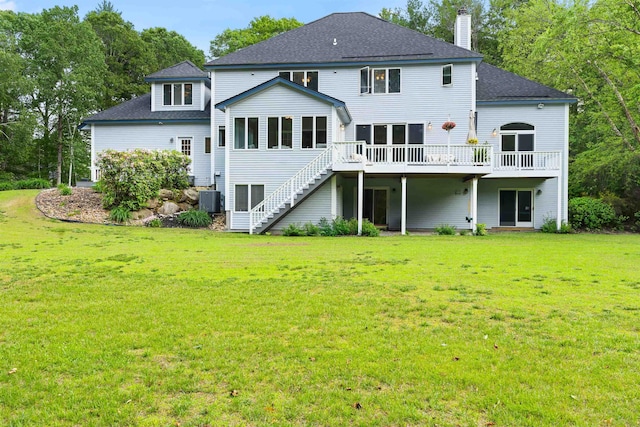 9 Hubbard Rd, Amherst, NH 03031 - back of property with a deck, a chimney, stairs, roof with shingles, and a lawn