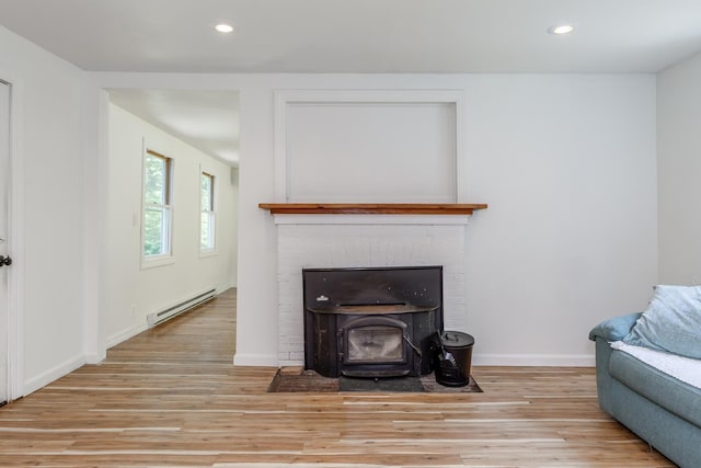 53 Broad Cove Dr, Concord, NH 03303 - living room featuring baseboard heating, light wood-style floors, recessed lighting, and a wood stove