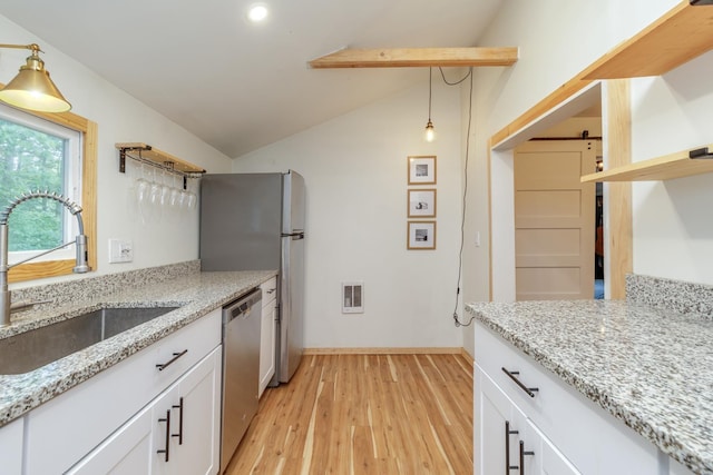 53 Broad Cove Dr, Concord, NH 03303 - kitchen featuring open shelves, vaulted ceiling, light wood-style flooring, stainless steel appliances, and white cabinets